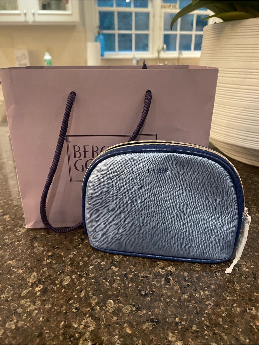 La Mer Light Blue Cosmetic Pouch with Bergdorf Goodman shopping bag